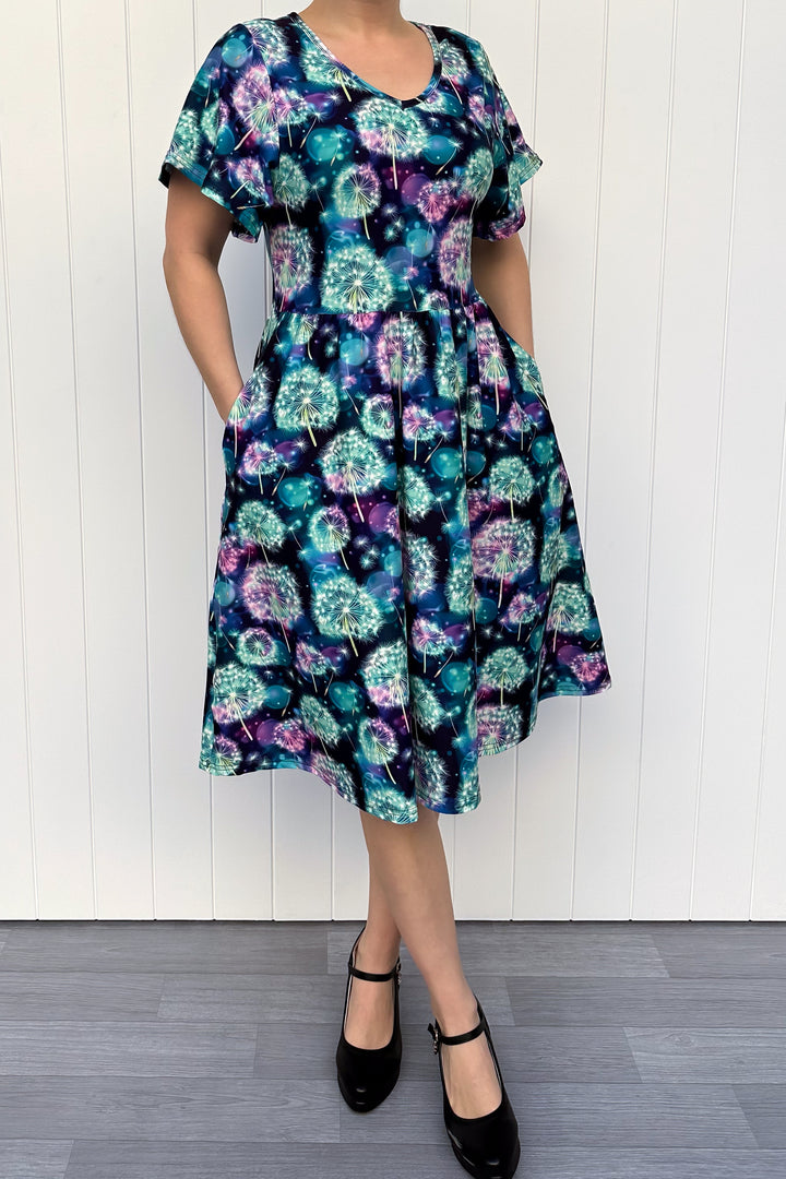 Woman wearing a floral dress with a white wooden background